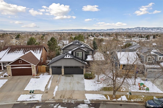 snowy aerial view featuring a mountain view