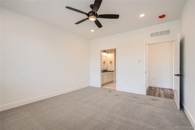 6874 Zuni Ct, Denver, CO 80221 - unfurnished bedroom with light carpet, recessed lighting, baseboards, connected bathroom, and ceiling fan