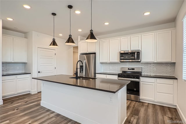 6874 Zuni Ct, Denver, CO 80221 - kitchen with appliances with stainless steel finishes, a sink, dark countertops, dark wood-style floors, and recessed lighting