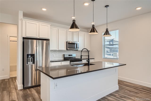 6874 Zuni Ct, Denver, CO 80221 - kitchen with stainless steel appliances, dark wood-type flooring, backsplash, white cabinetry, and recessed lighting