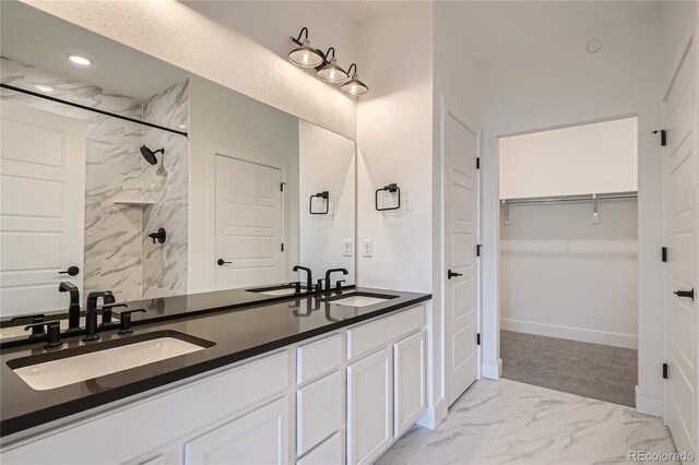 6874 Zuni Ct, Denver, CO 80221 - bathroom with a spacious closet, double vanity, marble finish floors, recessed lighting, and a shower