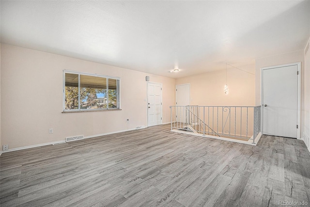 spare room with light hardwood / wood-style flooring