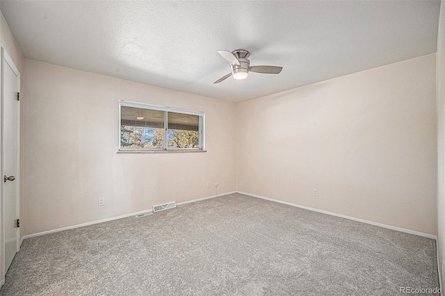 empty room featuring carpet flooring, ceiling fan, and a textured ceiling