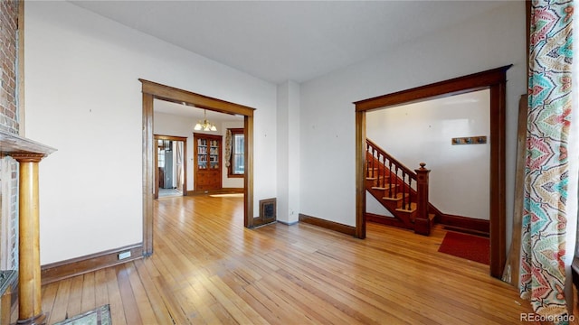 interior space with a chandelier and light wood-type flooring