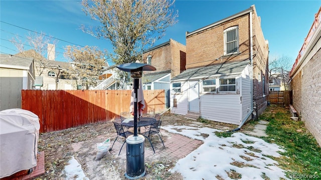 snow covered property with a patio