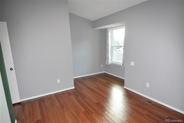 spare room featuring dark hardwood / wood-style floors