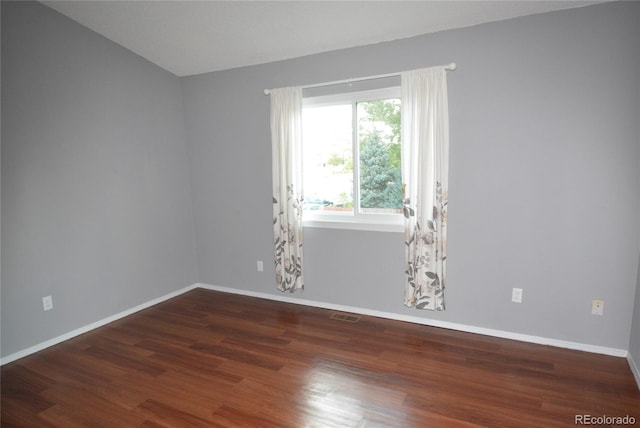 spare room featuring dark hardwood / wood-style flooring