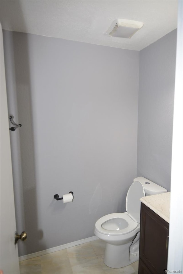 bathroom with vanity, toilet, and tile patterned floors