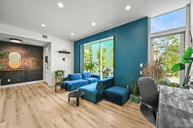 2565 Champa St, Denver, CO 80205 - living area with plenty of natural light, wood finished floors, recessed lighting, and an accent wall