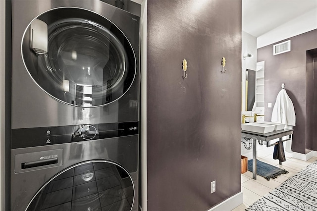 2565 Champa St, Denver, CO 80205 - laundry area with stacked washing machine and dryer and tile patterned flooring