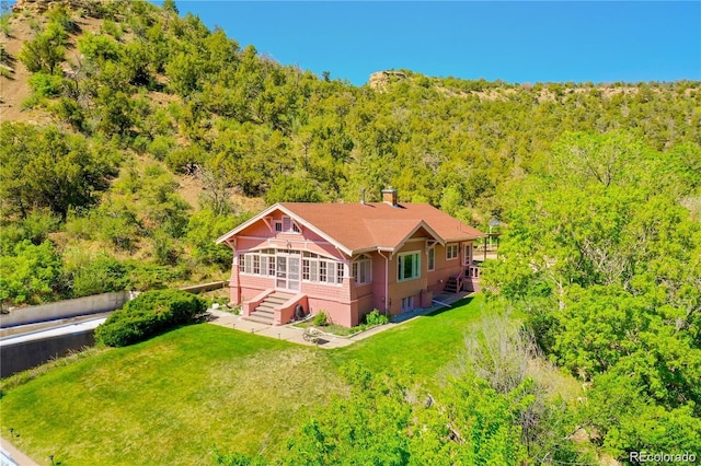 1133 Alta St, Trinidad, CO 81082 - view of front of house with a view of trees, stairs, a front yard, and a sunroom