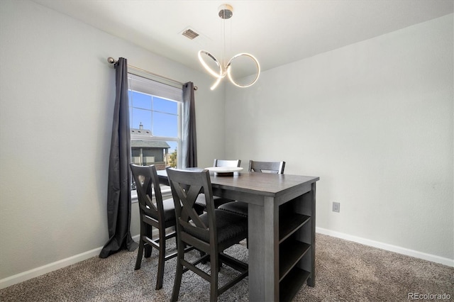 carpeted office featuring an inviting chandelier