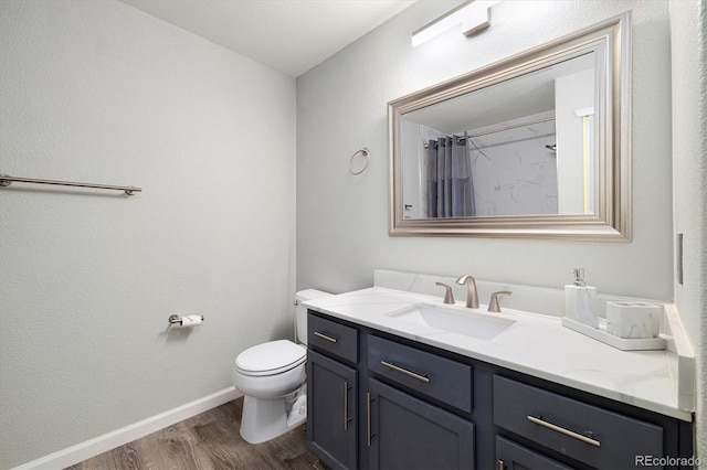 bathroom with vanity, wood-type flooring, walk in shower, and toilet