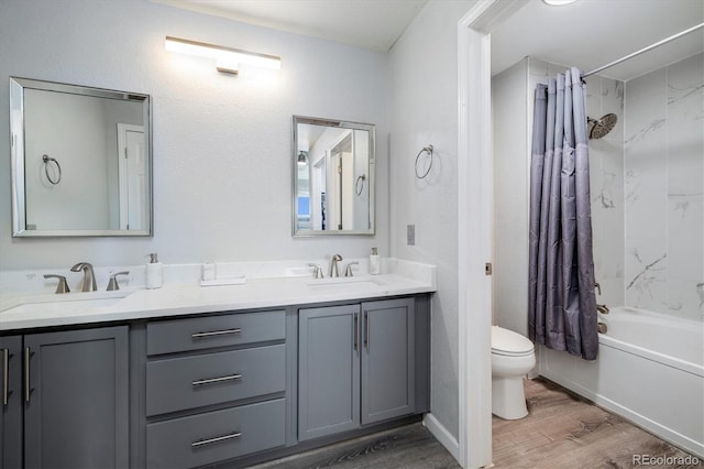 full bathroom with hardwood / wood-style flooring, shower / tub combo with curtain, vanity, and toilet