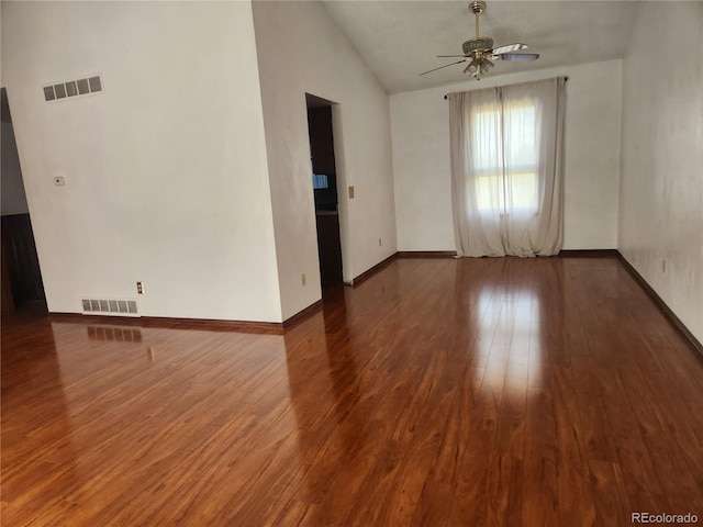 unfurnished room featuring a ceiling fan, baseboards, wood finished floors, lofted ceiling, and visible vents