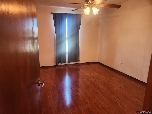 empty room featuring a ceiling fan and wood finished floors