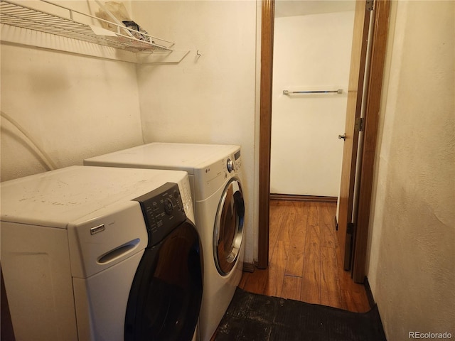 laundry area with separate washer and dryer, laundry area, and dark wood-style floors