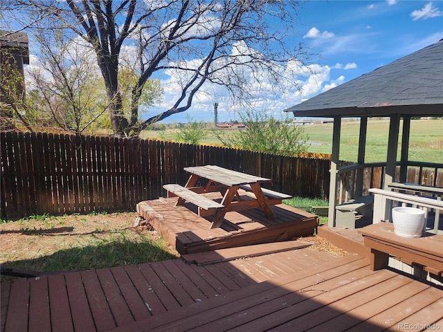 wooden deck with a gazebo and fence