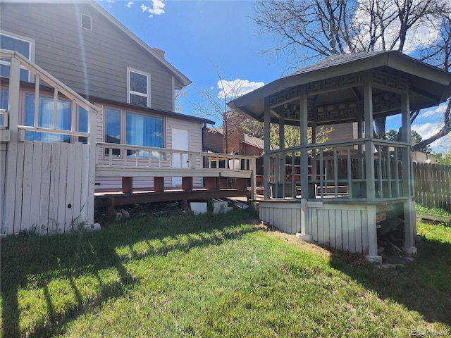 view of yard featuring fence and a wooden deck