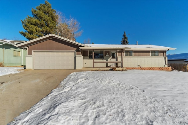 single story home with a garage and covered porch