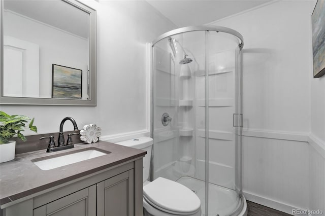 bathroom featuring vanity, toilet, and an enclosed shower