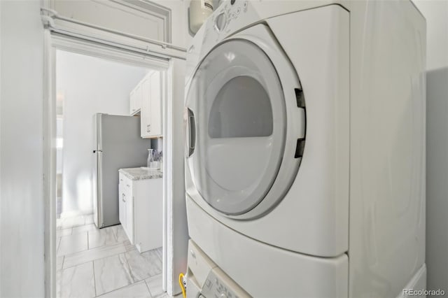 laundry room with stacked washing maching and dryer