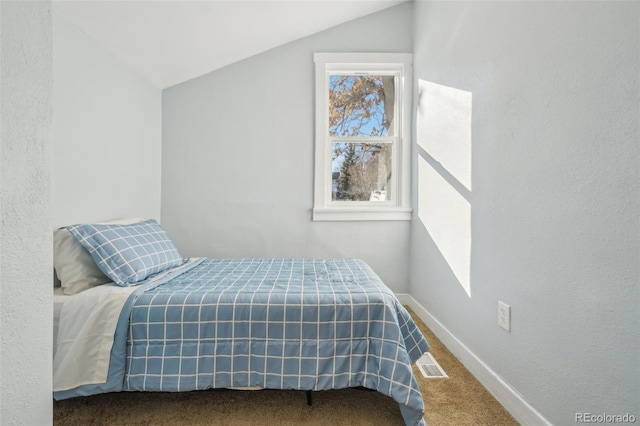 bedroom featuring carpet floors and vaulted ceiling