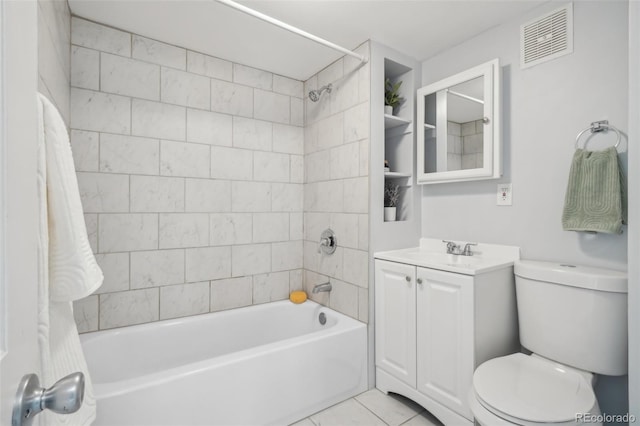 full bathroom featuring tile patterned floors, vanity, toilet, and tiled shower / bath combo