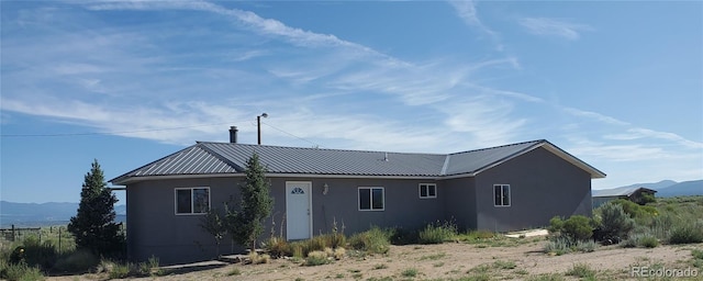 back of property featuring a mountain view