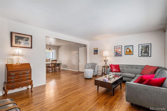 living room with hardwood / wood-style flooring and a chandelier