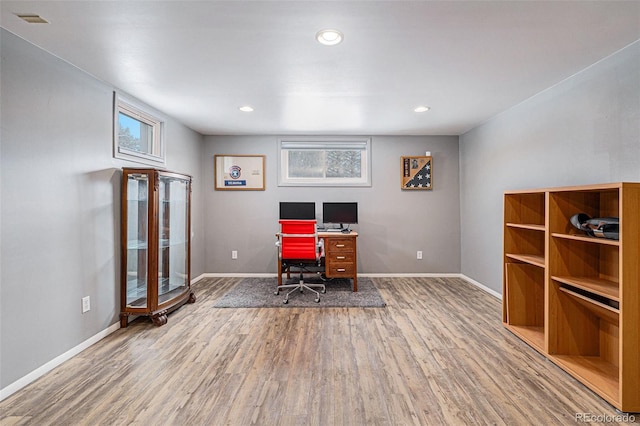 office space with wood-type flooring