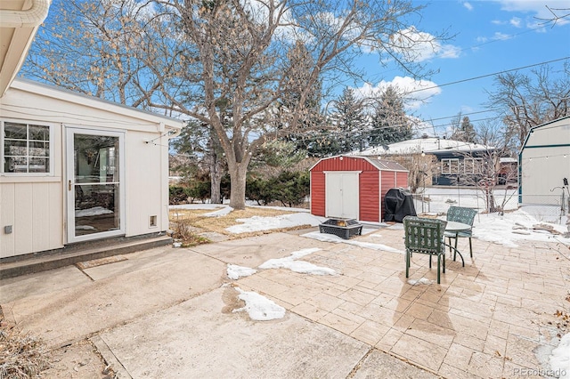 view of patio / terrace featuring grilling area and a storage unit