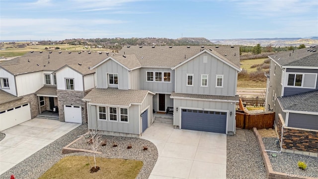 174 Rockingham Cir, Castle Pines, CO 80108 - traditional-style home with board and batten siding, driveway, a garage, fence, and a shingled roof