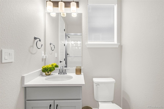 174 Rockingham Cir, Castle Pines, CO 80108 - bathroom featuring vanity, a shower with door, toilet, and a textured wall