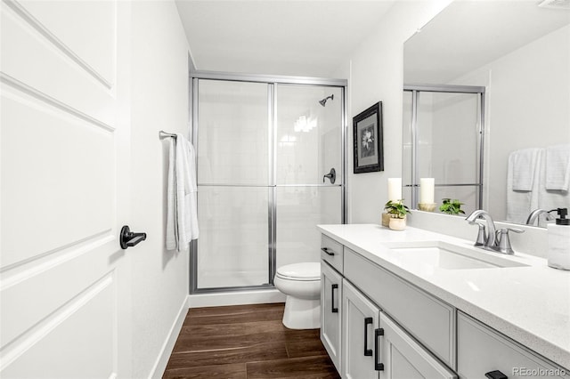 174 Rockingham Cir, Castle Pines, CO 80108 - full bathroom with a shower stall, wood finished floors, vanity, toilet, and baseboards