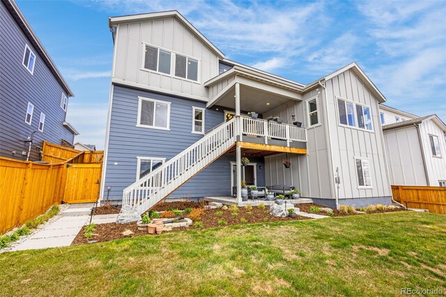 174 Rockingham Cir, Castle Pines, CO 80108 - back of house with board and batten siding, stairs, and a patio