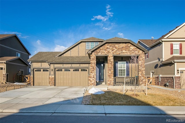 4722 S Netherland St, Centennial, CO 80015 - view of front of home with an attached garage, concrete driveway, stone siding, covered porch, and roof with shingles