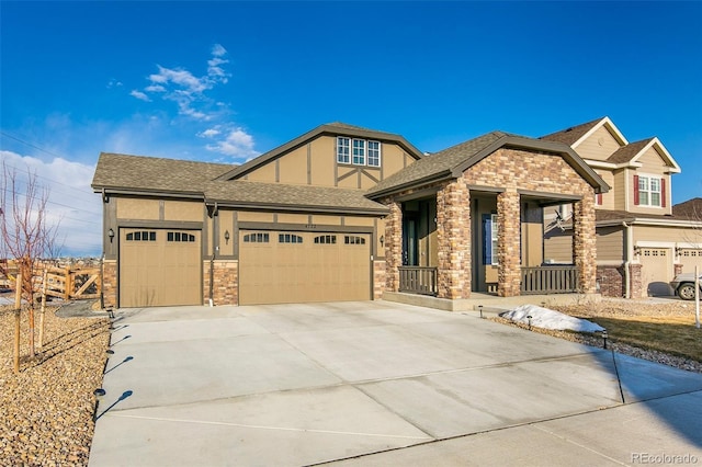 4722 S Netherland St, Centennial, CO 80015 - view of front of home featuring concrete driveway, a garage, stone siding, a porch, and roof with shingles