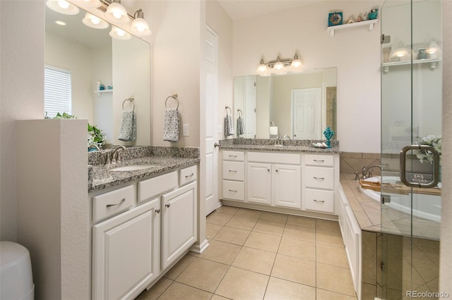 4722 S Netherland St, Centennial, CO 80015 - bathroom featuring tile patterned floors, two vanities, a bath, and a stall shower