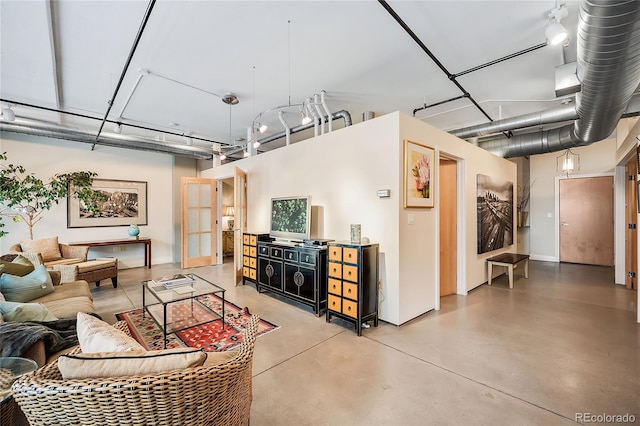 living room featuring concrete flooring