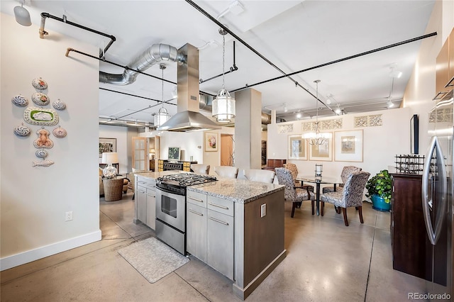 kitchen with gas stove, island range hood, hanging light fixtures, and light stone counters