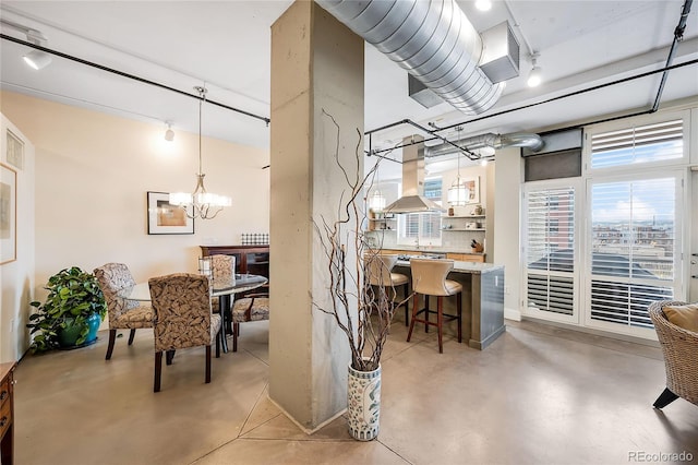 1610 Little Raven St Unit 407, Denver, CO 80202 - dining area featuring concrete floors, a chandelier, and track lighting