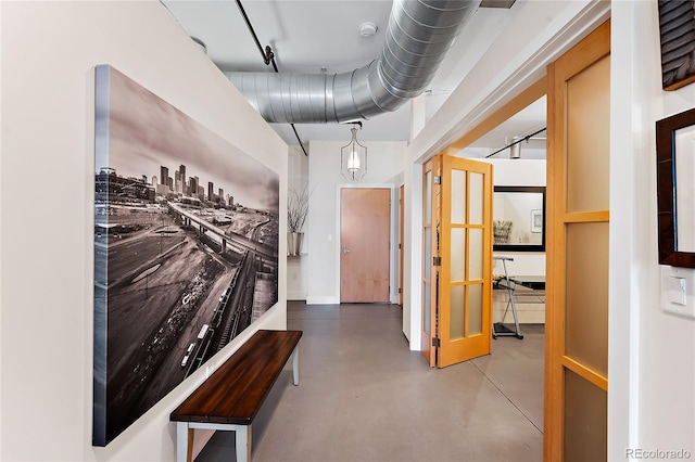 hallway with concrete flooring