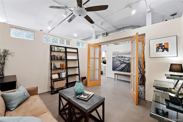 living room featuring ceiling fan and french doors