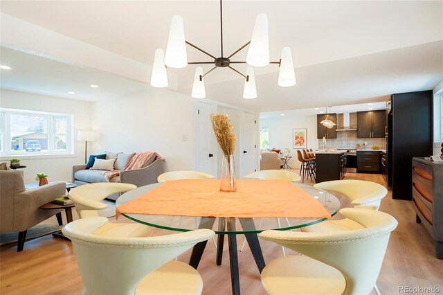 6325 W Portland Pl, Littleton, CO 80128 - dining area with plenty of natural light, light wood finished floors, a chandelier, and recessed lighting