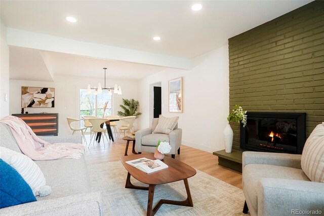 6325 W Portland Pl, Littleton, CO 80128 - living area featuring a fireplace, a chandelier, light wood-style flooring, and recessed lighting