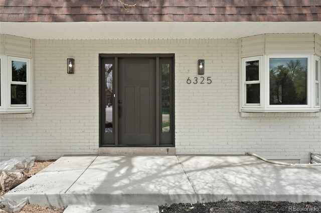 6325 W Portland Pl, Littleton, CO 80128 - property entrance featuring brick siding