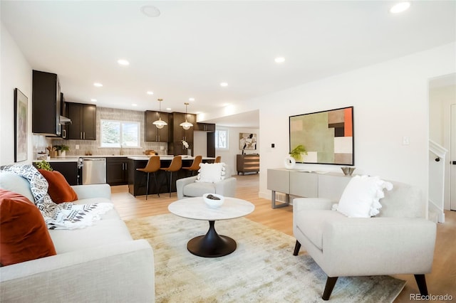6325 W Portland Pl, Littleton, CO 80128 - living room featuring light wood-type flooring and recessed lighting
