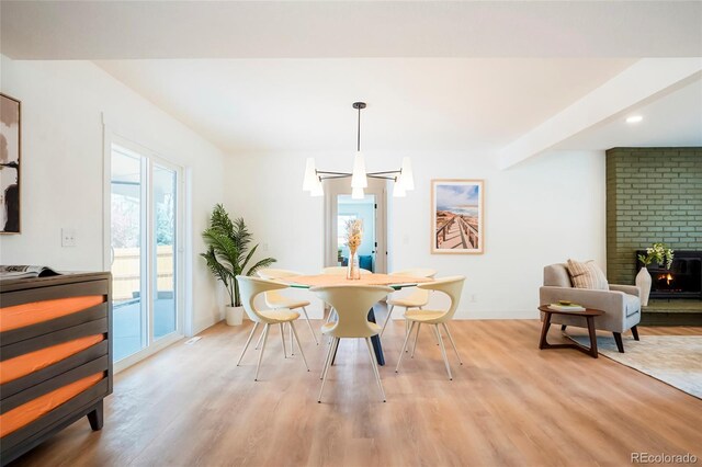 6325 W Portland Pl, Littleton, CO 80128 - dining space with light wood-type flooring, a large fireplace, baseboards, and recessed lighting