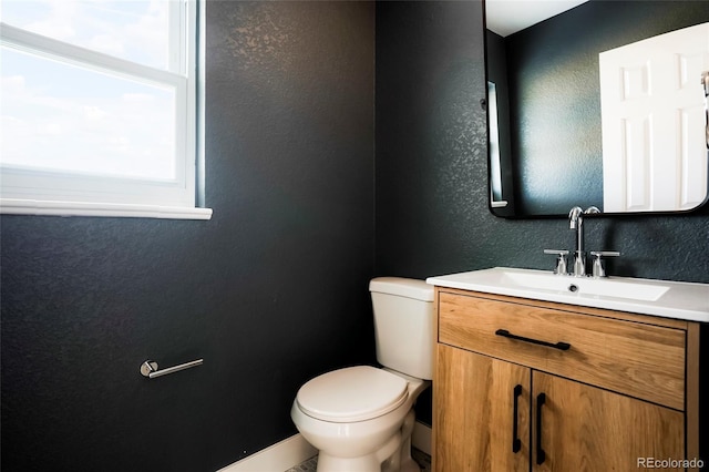 6325 W Portland Pl, Littleton, CO 80128 - half bath with a textured wall, toilet, vanity, and baseboards